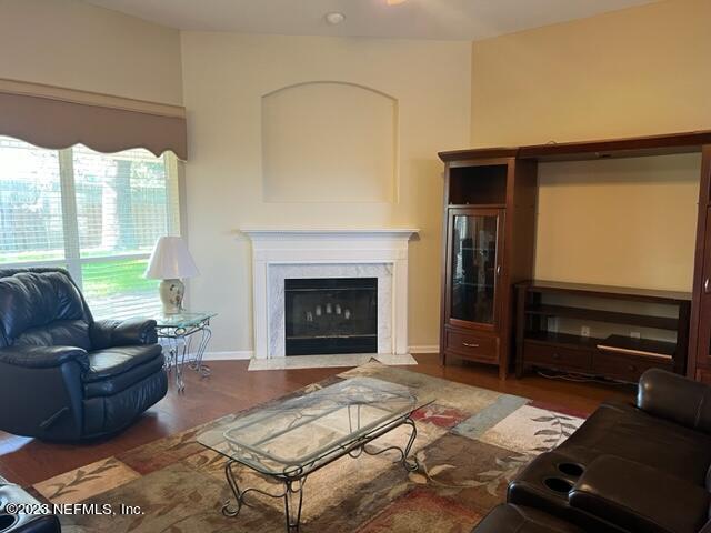 10321 Sugar Grove Road Jacksonville, FL 32221 - Photo 10 of 34 a living room with furniture flat screen tv and a fireplace