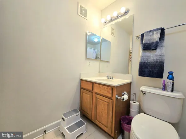 a bathroom with a sink mirror vanity and toilet