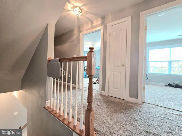 a view of staircase with wooden floor and windows