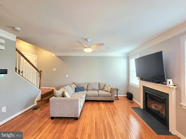 a kitchen with stainless steel appliances granite countertop a refrigerator a stove top oven a sink and dishwasher with wooden floor