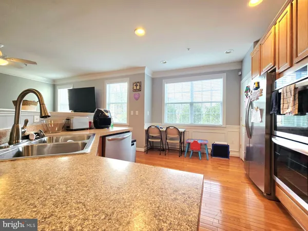 a kitchen with stainless steel appliances a sink a stove and a window