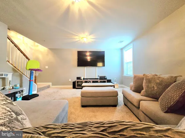 a living room with furniture and a dining table