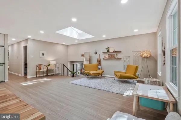 a living room with lots of furniture and a wooden floor