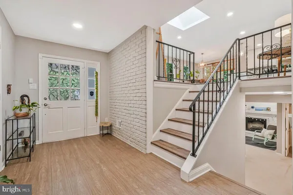 a view of entryway with wooden floor and stairs