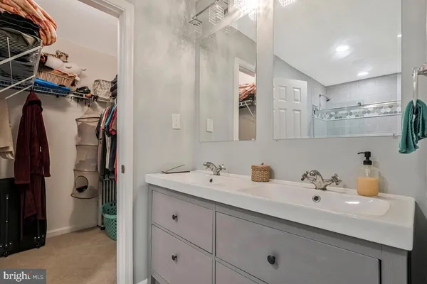 a bathroom with a double vanity sink a mirror and shower