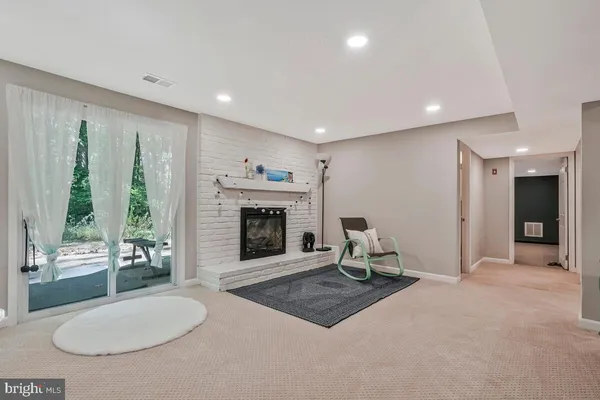 a living room with furniture a fireplace and a table