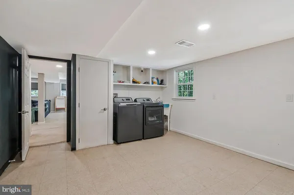 a kitchen with stainless steel appliances granite countertop a stove a refrigerator and a refrigerator with wooden floor