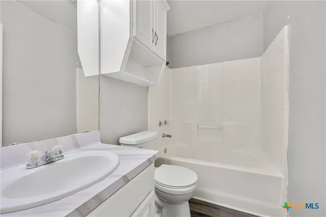 a bathroom with a sink a toilet and a bathtub