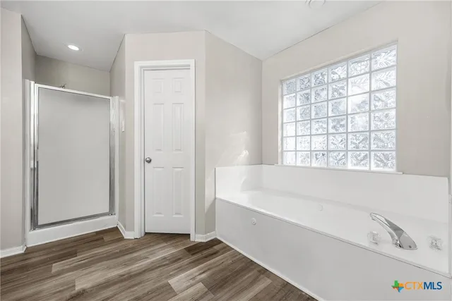 a bathroom with a bathtub and a shower