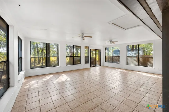 a view of an empty room with windows