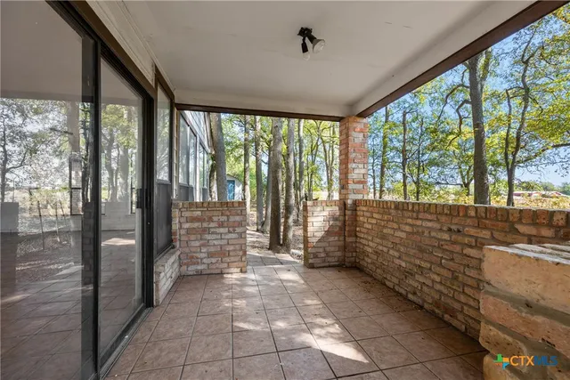 a view of hallway with large windows