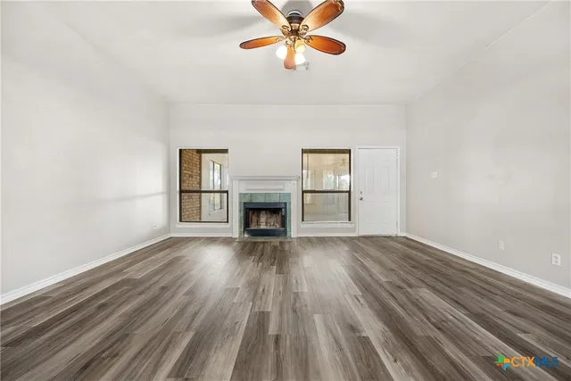 wooden floor in an empty room with a window