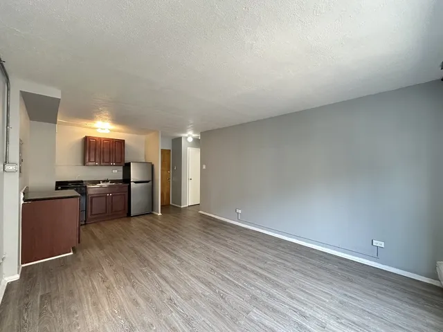 a view of a room with wooden floor and window
