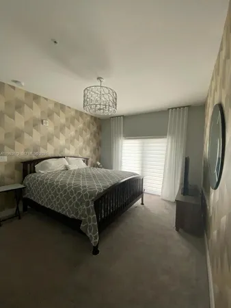 a bedroom with a bed and a mirror