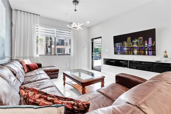 a living room with furniture and a chandelier