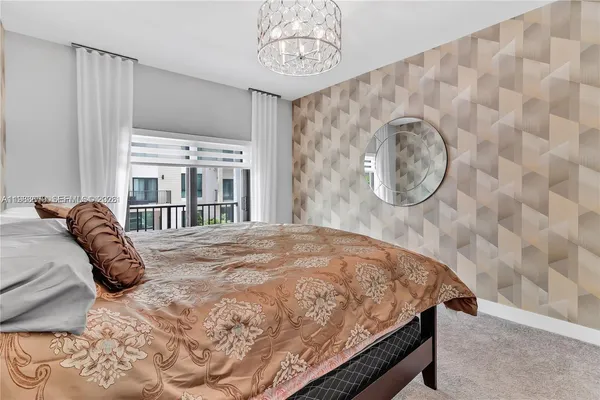 a large bed sitting in a bedroom next to a cabinet