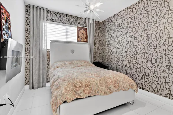 a bedroom with a bed and a television