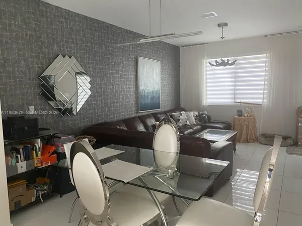 a view of a dining room with furniture and chandelier