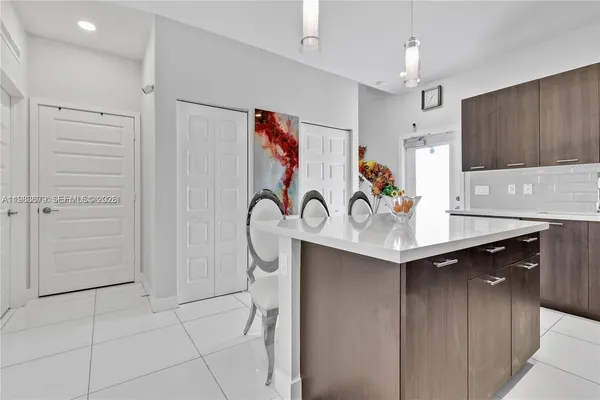a kitchen with stainless steel appliances a sink cabinets and wooden floor