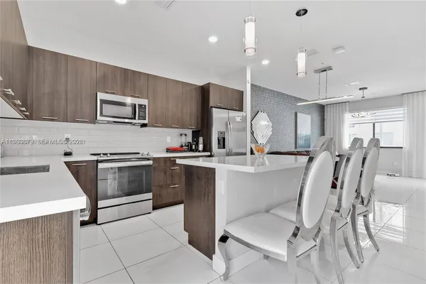 a kitchen with cabinets a sink and appliances