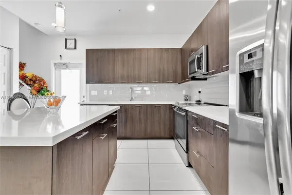 a kitchen with stainless steel appliances granite countertop a sink and cabinets