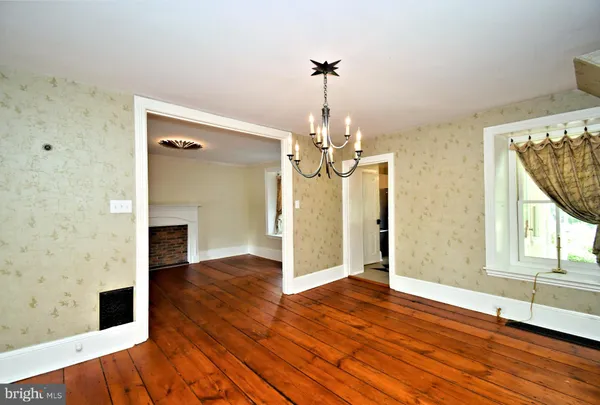 a kitchen with stainless steel appliances a stove a refrigerator a sink and white cabinets