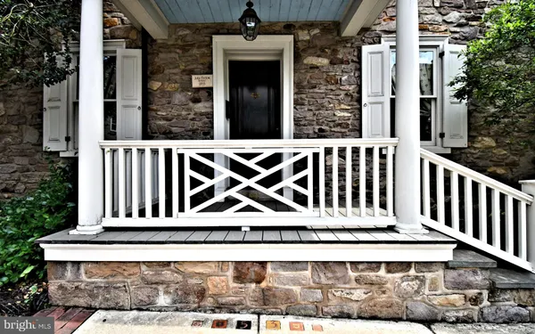 a view of a livingroom with wooden floor and a kitchen space