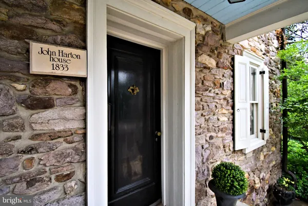 a view of a livingroom with wooden floor a fireplace and window
