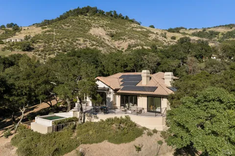 aerial view of a house with yard porch and furniture