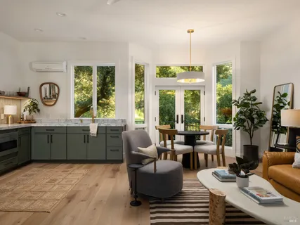a kitchen with kitchen island granite countertop a sink cabinets and stainless steel appliances