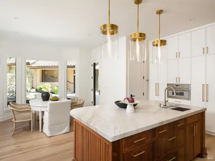 a kitchen with a sink stove top oven and cabinets