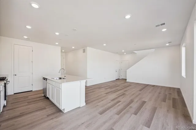 a view of kitchen with wooden floor and window