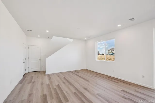 a view of room with wooden floor and window