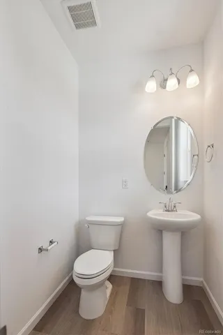 a bathroom with a sink mirror and toilet
