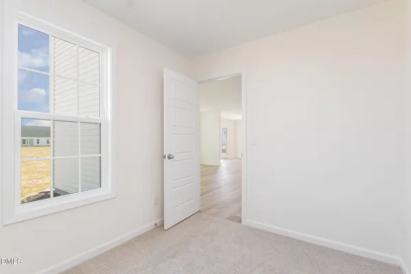 an empty room with a empty space and windows
