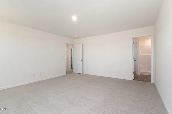 a view of a white house with a yard and a large window