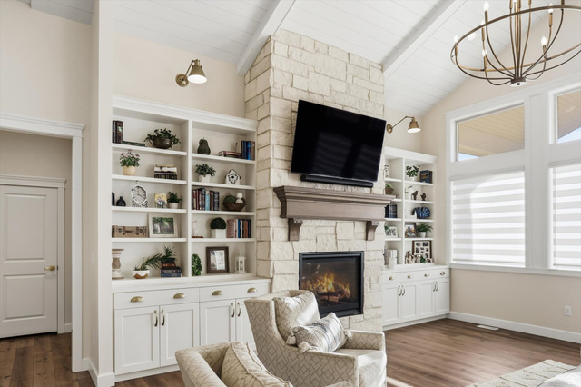 534 East Fish Hatchery Road Mantua, UT 84324 - Photo 29 of 87 Living area with dark wood-style flooring, a stone fireplace, suspended lighting, lofted ceiling with beams, and wooden ceiling