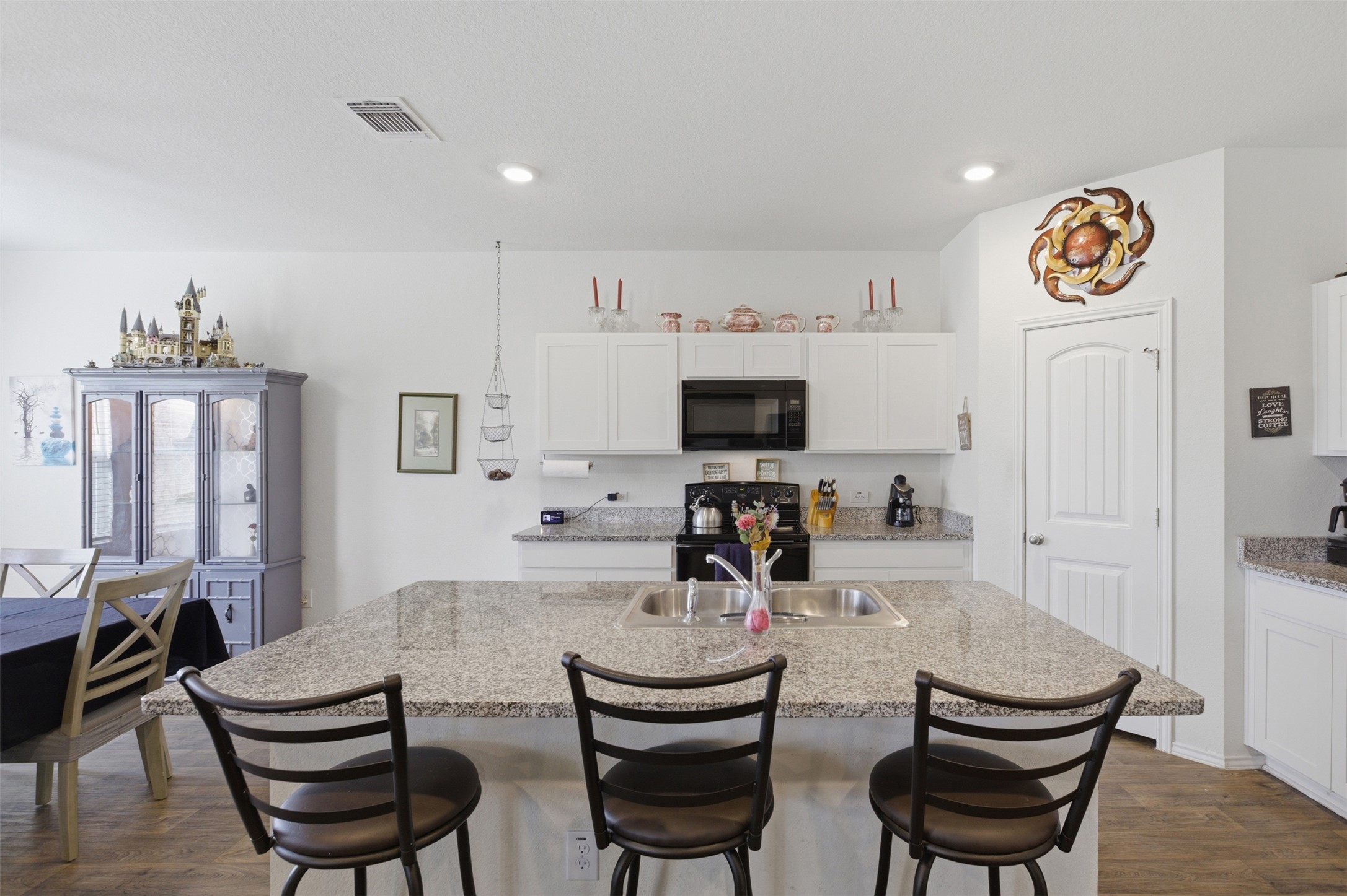 19017 Romano Drive Elgin, TX 78621 - Photo 16 of 33 Spacious kitchen island featuring a double basin sink and ample seating