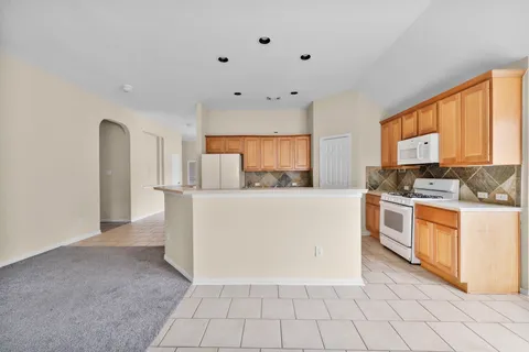 a kitchen with stainless steel appliances a refrigerator sink and cabinets