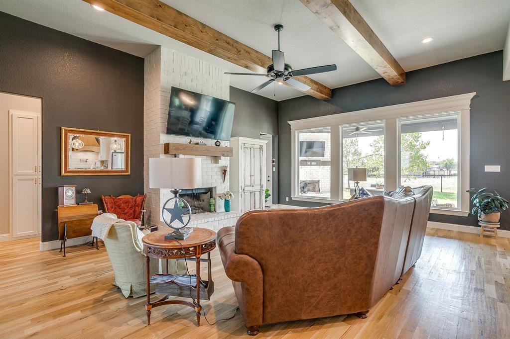 116 Aviara Ridge Road Poolville, TX 76487 - Photo 10 of 38 a living room with furniture a flat screen tv and wooden floor