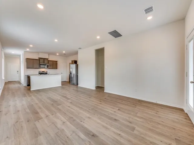 a view of a kitchen with a sink and a refrigerator