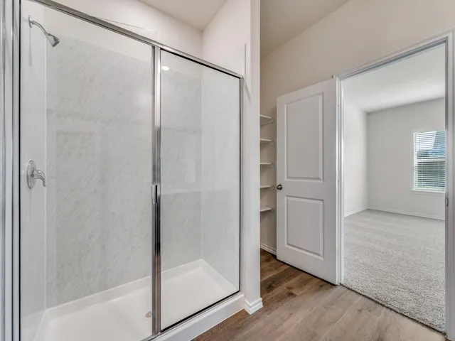 a bathroom with a glass shower door
