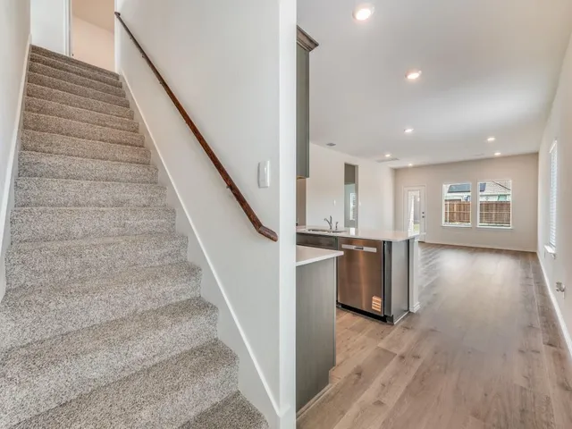 a view of an entryway with wooden floor and staircase