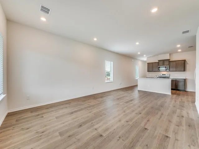 a view of a kitchen with a sink and a refrigerator