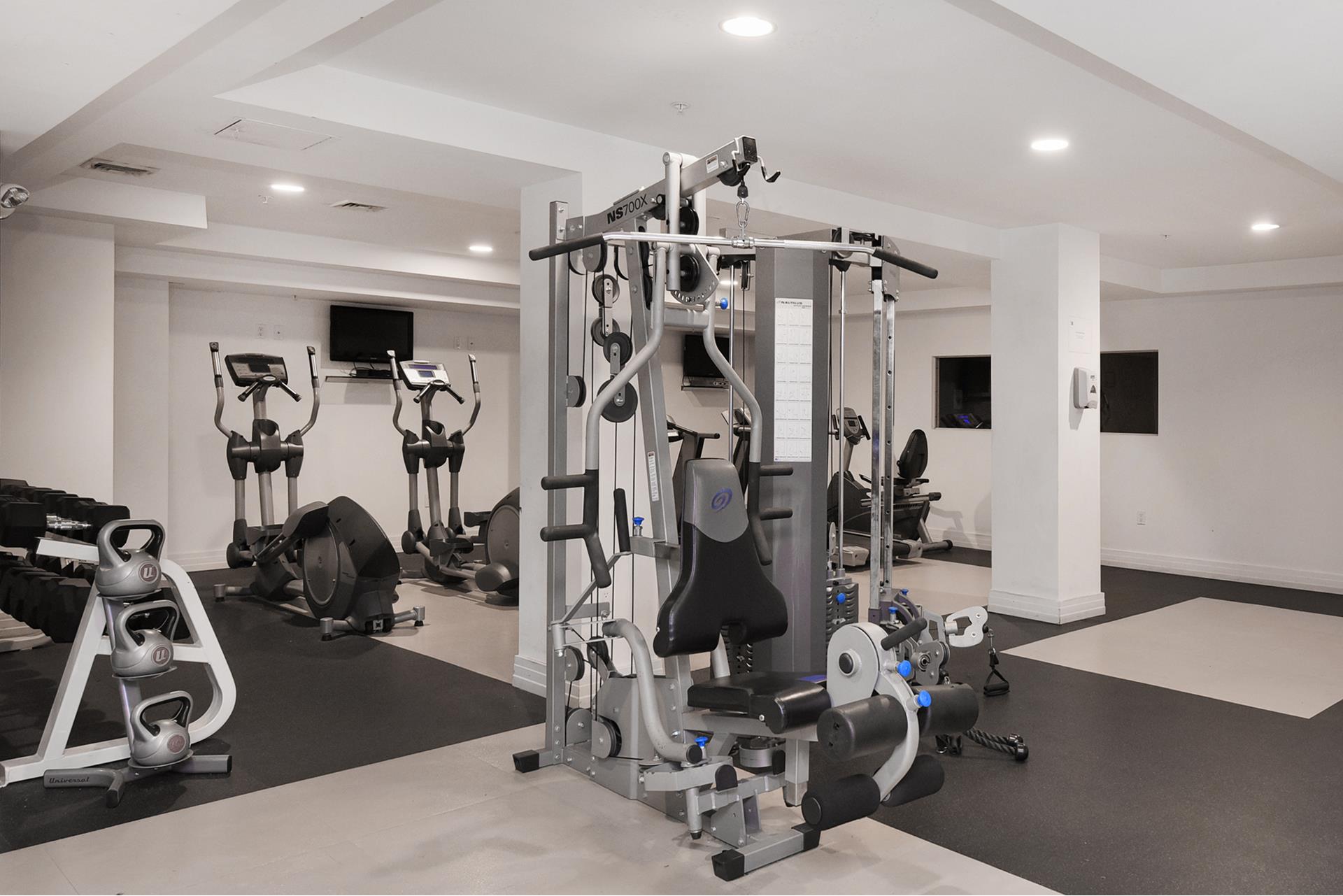 64-05 Yellowstone Boulevard, Unit TH105 Queens, NY 11375 - Photo 16 of 25 a view of a room with gym equipment