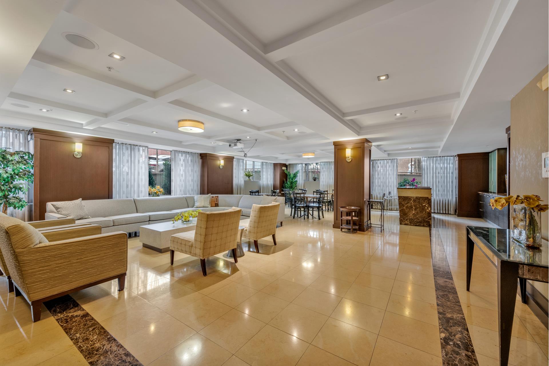 64-05 Yellowstone Boulevard, Unit TH105 Queens, NY 11375 - Photo 19 of 25 a living room with furniture and a flat screen tv