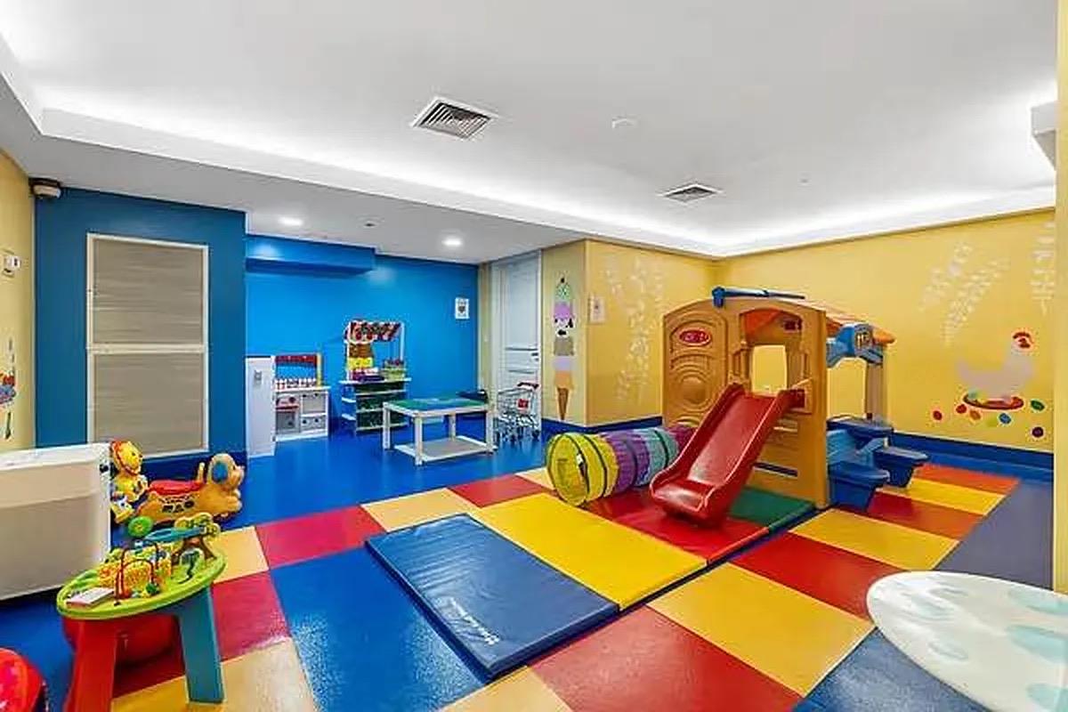 64-05 Yellowstone Boulevard, Unit TH105 Queens, NY 11375 - Photo 21 of 25 a living room with furniture and wooden floor