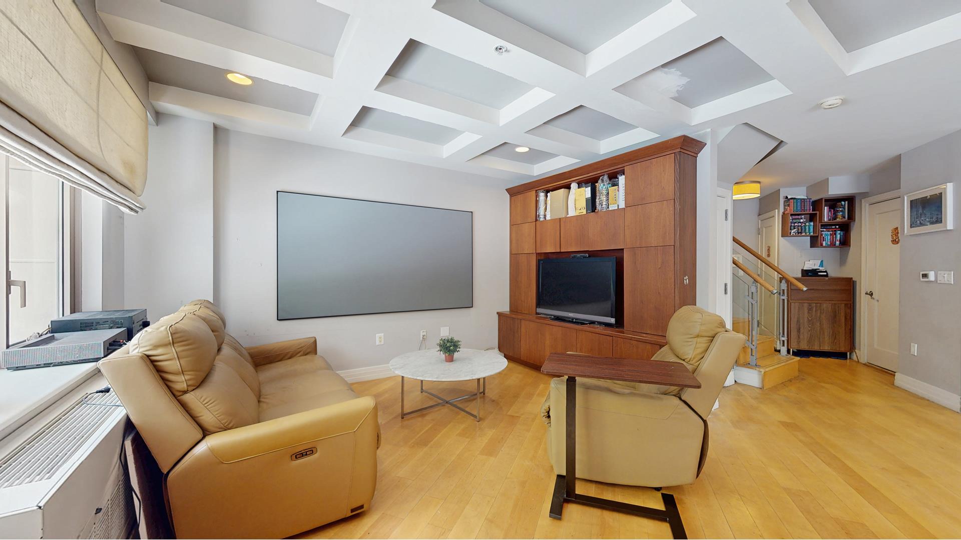 64-05 Yellowstone Boulevard, Unit TH105 Queens, NY 11375 - Photo 2 of 25 a living room with furniture and a flat screen tv