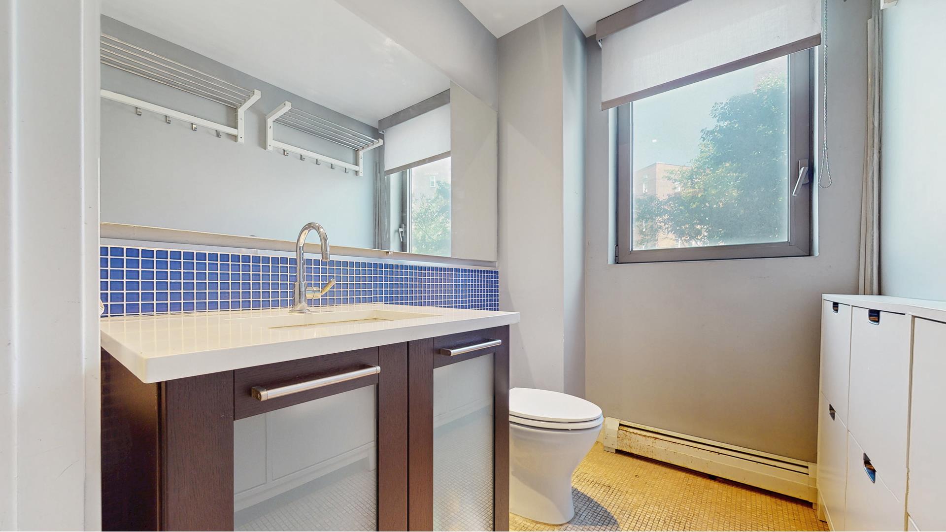 64-05 Yellowstone Boulevard, Unit TH105 Queens, NY 11375 - Photo 6 of 25 a view of bathroom with a sink and mirror