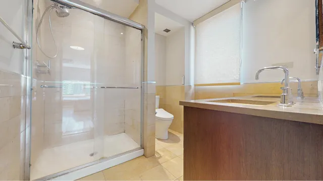 a view of bathroom with a sink and mirror